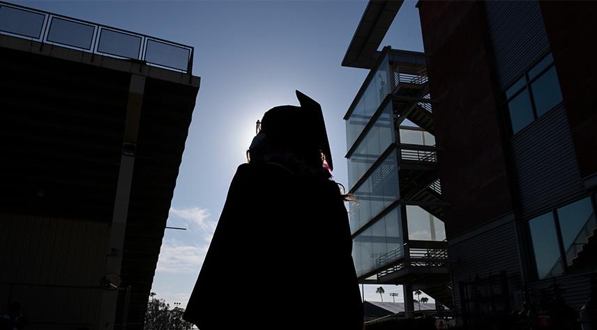 A shadow of a student in regalia